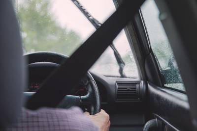 person driving car over shoulder image